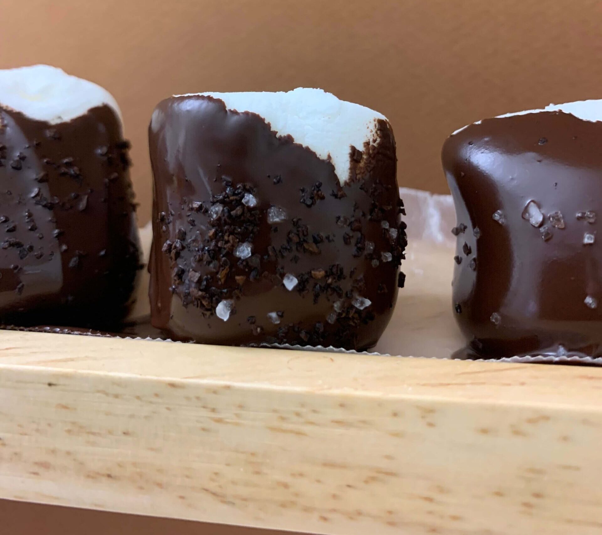 Chocolate-covered marshmallows with toppings